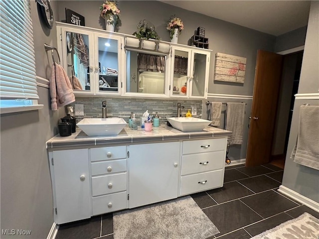 567 Westfield Rd, East Liverpool, OH 43920 - bathroom featuring tile patterned flooring, double vanity, baseboards, and tasteful backsplash