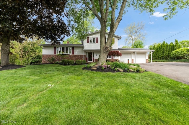7456 Blue Ridge Dr, Mentor, OH 44060 - tri-level home featuring brick siding, asphalt driveway, a garage, and a front yard