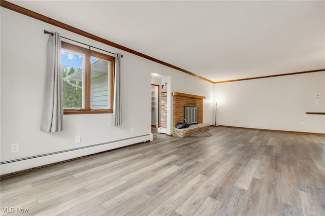 7456 Blue Ridge Dr, Mentor, OH 44060 - unfurnished living room featuring a baseboard radiator, light wood-style floors, crown molding, a fireplace, and baseboards