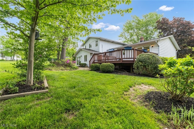 7456 Blue Ridge Dr, Mentor, OH 44060 - back of house with a wooden deck, a yard, and a chimney