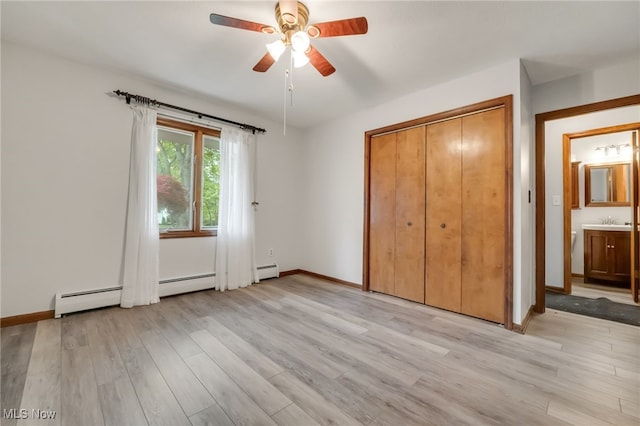 7456 Blue Ridge Dr, Mentor, OH 44060 - unfurnished bedroom featuring light wood-style floors, a baseboard radiator, a sink, and baseboards