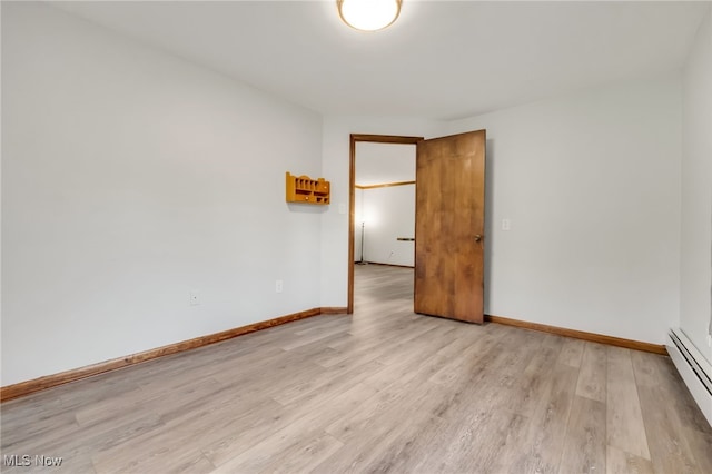 7456 Blue Ridge Dr, Mentor, OH 44060 - spare room featuring a baseboard radiator, light wood-style floors, and baseboards