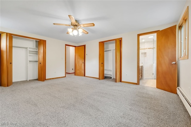 7456 Blue Ridge Dr, Mentor, OH 44060 - unfurnished bedroom featuring a baseboard heating unit, multiple closets, light colored carpet, and baseboards