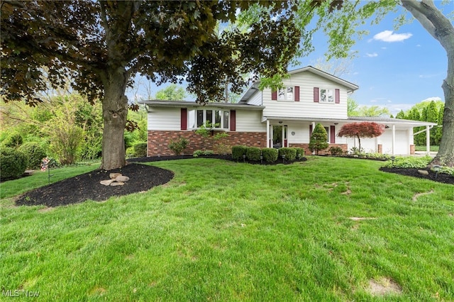 7456 Blue Ridge Dr, Mentor, OH 44060 - tri-level home featuring brick siding, an attached garage, a front lawn, and covered porch