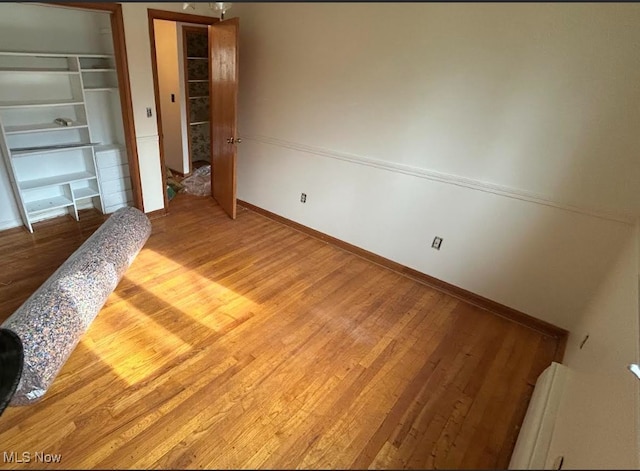 7456 Blue Ridge Dr, Mentor, OH 44060 - unfurnished bedroom featuring wood finished floors, a closet, and baseboards