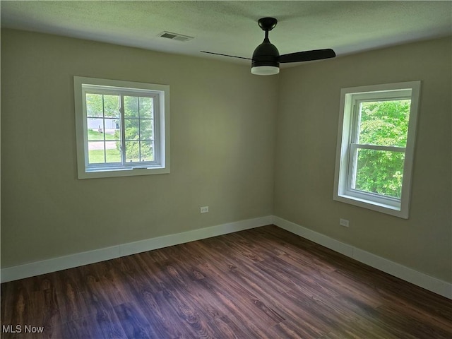 355 N Elm Ave, Tallmadge, OH 44278 - empty room featuring healthy amount of natural light, a ceiling fan, baseboards, and dark wood finished floors