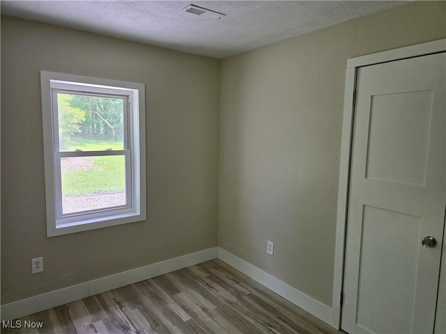 355 N Elm Ave, Tallmadge, OH 44278 - empty room featuring a textured ceiling, wood finished floors, and baseboards