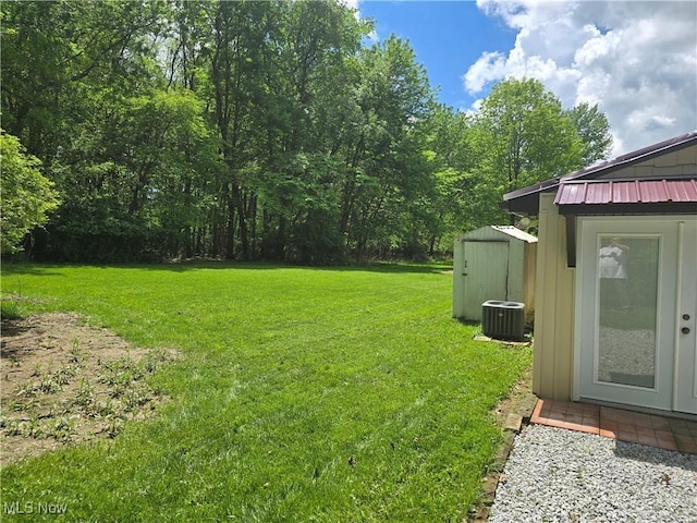 355 N Elm Ave, Tallmadge, OH 44278 - view of green lawn featuring a shed, central air condition unit, and an outdoor structure