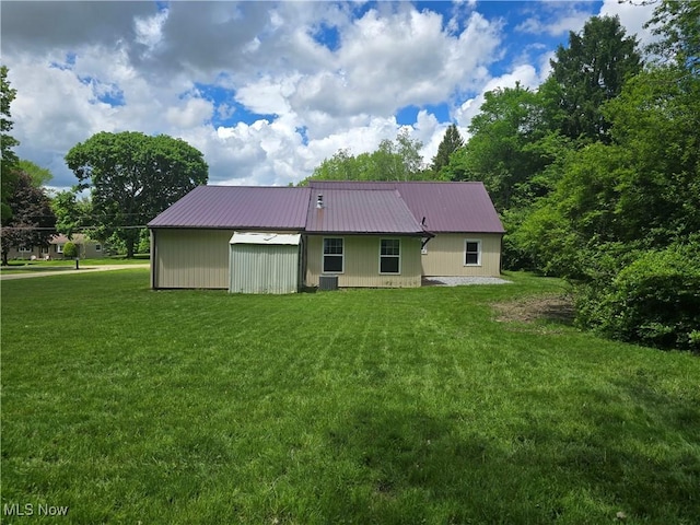 355 N Elm Ave, Tallmadge, OH 44278 - back of house with a yard, metal roof, and central AC