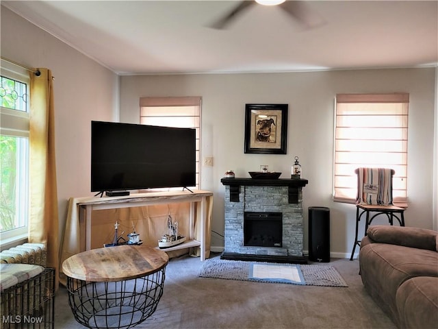 517 N 10th St, Cambridge, OH 43725 - carpeted living area with a ceiling fan, crown molding, a stone fireplace, and baseboards