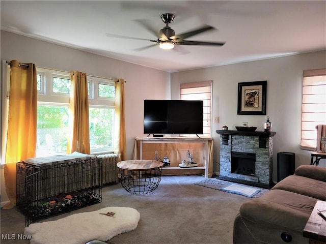 517 N 10th St, Cambridge, OH 43725 - carpeted living area featuring a ceiling fan and a fireplace