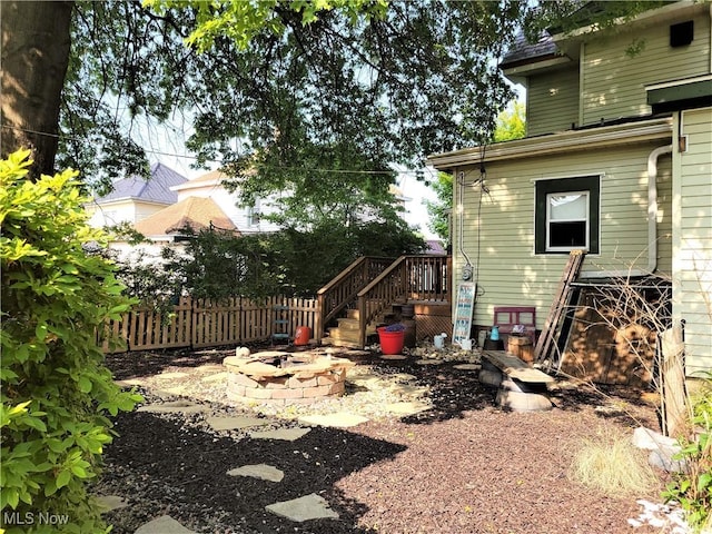 517 N 10th St, Cambridge, OH 43725 - view of yard featuring an outdoor fire pit, fence, and stairs