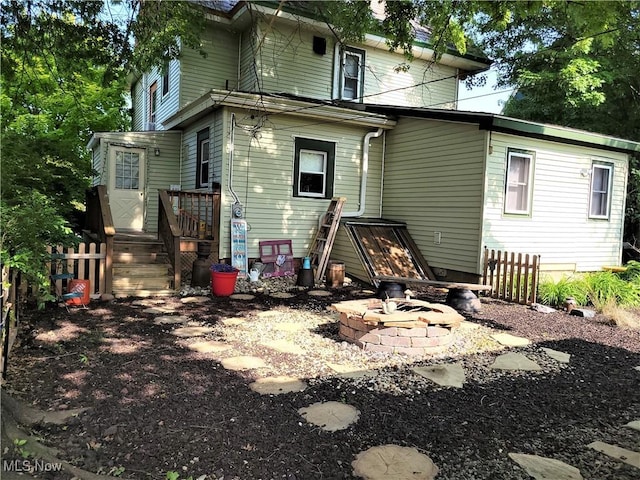 517 N 10th St, Cambridge, OH 43725 - rear view of property with an outdoor fire pit, fence, and a deck