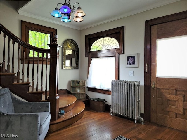 517 N 10th St, Cambridge, OH 43725 - foyer entrance featuring radiator, plenty of natural light, stairway, a chandelier, and crown molding