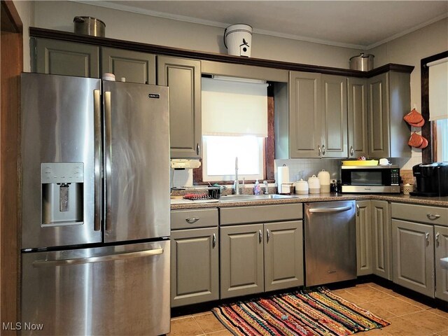 517 N 10th St, Cambridge, OH 43725 - kitchen with appliances with stainless steel finishes, a sink, gray cabinets, light tile patterned flooring, and tasteful backsplash
