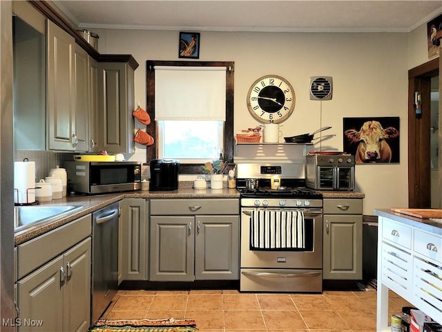 517 N 10th St, Cambridge, OH 43725 - kitchen featuring stainless steel appliances, gray cabinetry, crown molding, dark countertops, and light tile patterned flooring