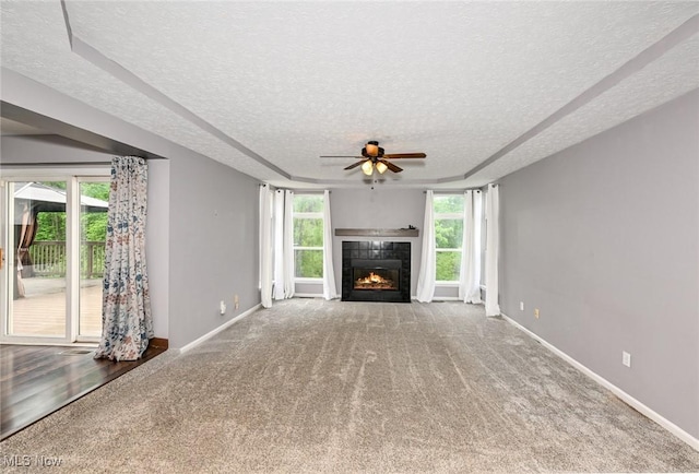 4474 Litchfield Dr, Copley, OH 44321 - unfurnished living room featuring a textured ceiling, ceiling fan, carpet floors, a fireplace, and baseboards