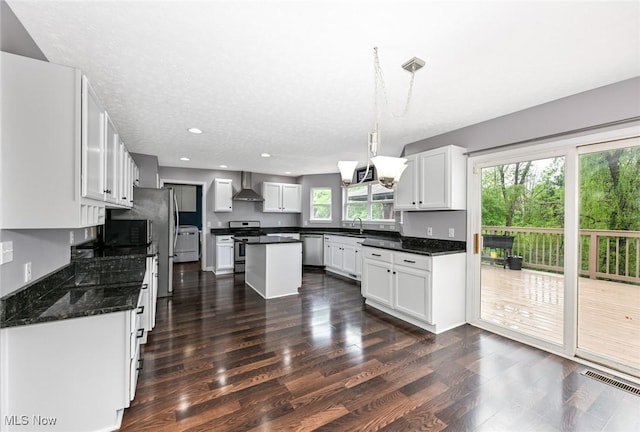 4474 Litchfield Dr, Copley, OH 44321 - kitchen with wall chimney range hood, stainless steel appliances, dark wood finished floors, white cabinetry, and recessed lighting