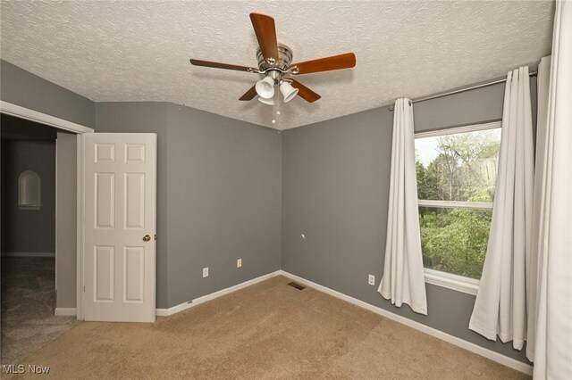 4474 Litchfield Dr, Copley, OH 44321 - unfurnished room featuring ceiling fan, carpet flooring, baseboards, and a textured ceiling