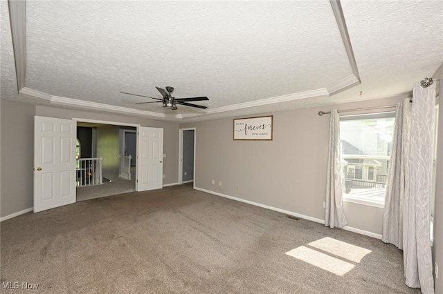 4474 Litchfield Dr, Copley, OH 44321 - carpeted spare room with a textured ceiling, ornamental molding, a ceiling fan, baseboards, and a raised ceiling