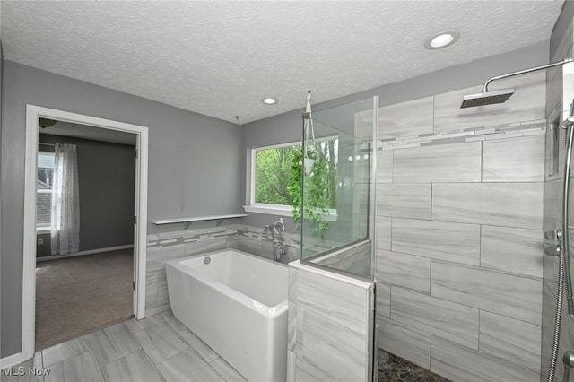 4474 Litchfield Dr, Copley, OH 44321 - full bathroom with a garden tub, tiled shower, a textured ceiling, and recessed lighting