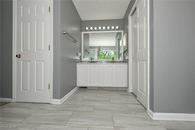 4474 Litchfield Dr, Copley, OH 44321 - bathroom with baseboards and double vanity