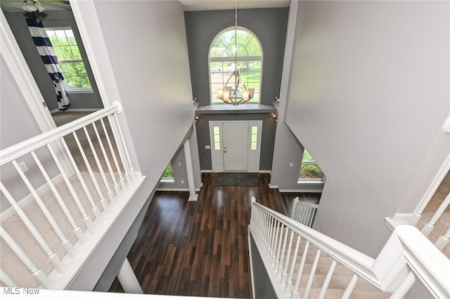 4474 Litchfield Dr, Copley, OH 44321 - entryway with stairway, wood finished floors, healthy amount of natural light, a towering ceiling, and baseboards