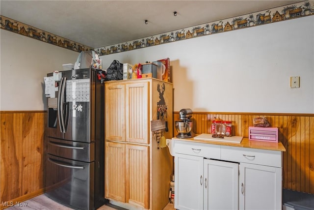 55 Lanham Ln, Davisville, WV 26142 - kitchen with stainless steel refrigerator with ice dispenser, wood walls, a wainscoted wall, light countertops, and white cabinets