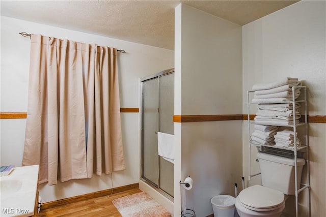 55 Lanham Ln, Davisville, WV 26142 - bathroom featuring wood finished floors, a stall shower, toilet, and vanity