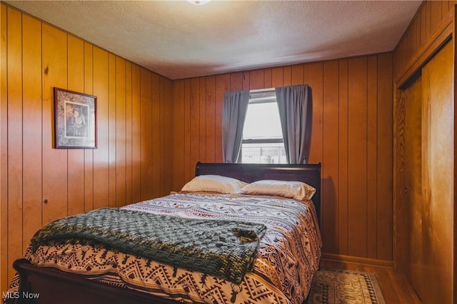 55 Lanham Ln, Davisville, WV 26142 - bedroom featuring wood finished floors, wood walls, and a textured ceiling