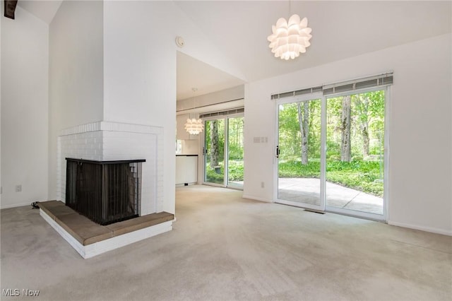 12562 Harold Dr, Chesterland, OH 44026 - unfurnished living room with carpet floors, a brick fireplace, healthy amount of natural light, and vaulted ceiling