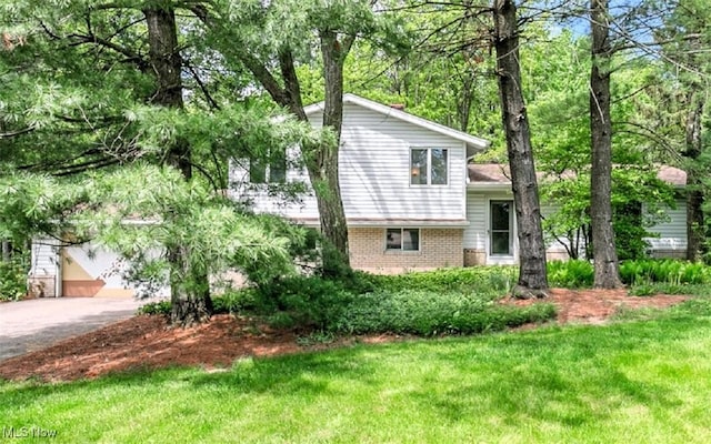 12562 Harold Dr, Chesterland, OH 44026 - tri-level home featuring brick siding, a front lawn, and asphalt driveway