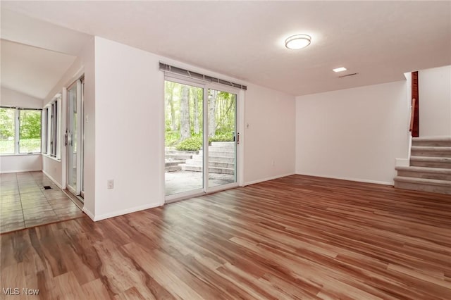 12562 Harold Dr, Chesterland, OH 44026 - spare room featuring baseboards, wood finished floors, stairway, and lofted ceiling