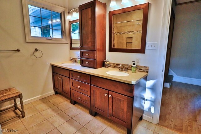 24514 County Road 24, Coshocton, OH 43812 - bathroom featuring baseboards, tile patterned floors, and double vanity
