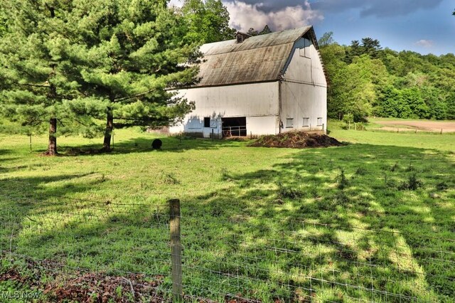 24514 County Road 24, Coshocton, OH 43812 - view of home's exterior with a barn, an outdoor structure, and a lawn