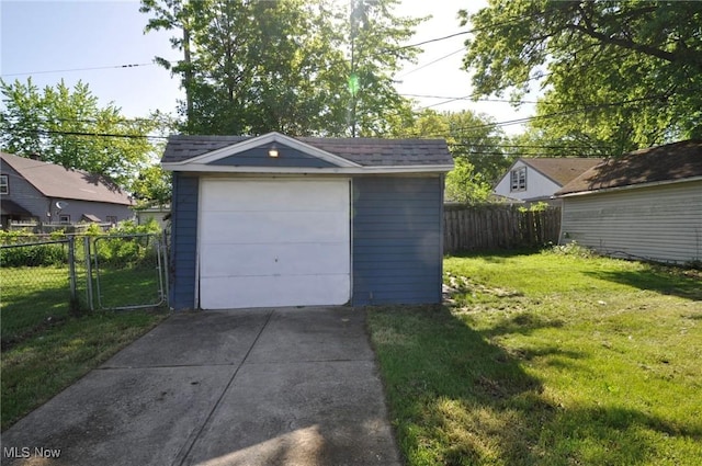 detached garage with concrete driveway
