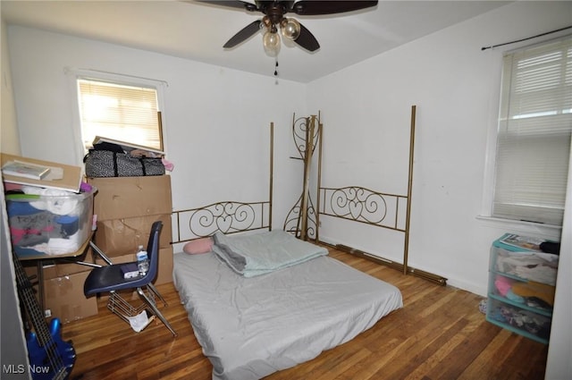 bedroom featuring wood finished floors and a ceiling fan