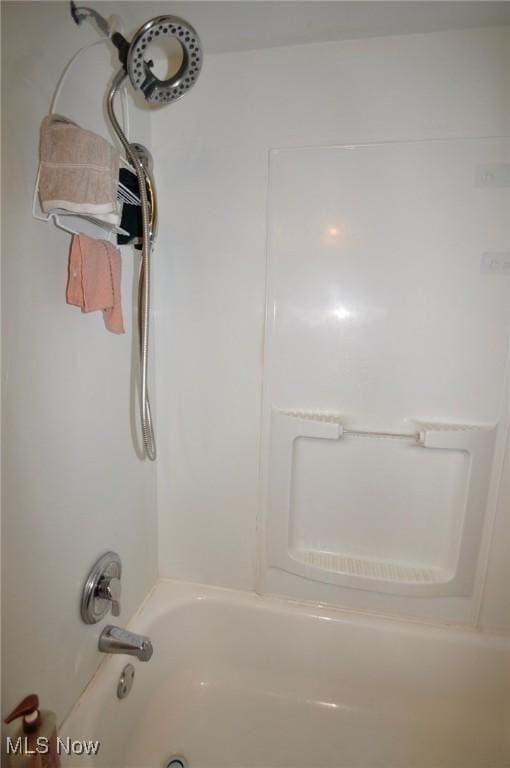 bathroom view of shower / tub combination