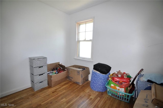 rec room featuring wood finished floors and baseboards