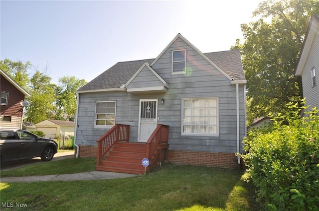 bungalow-style home featuring a shingled roof and a front lawn