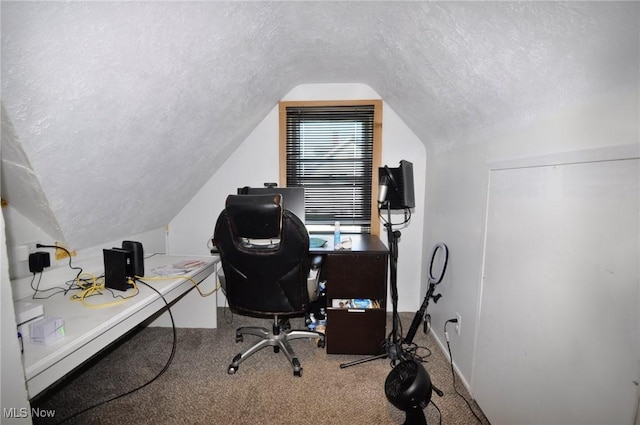 office area featuring a textured ceiling, lofted ceiling, carpet flooring, and baseboards
