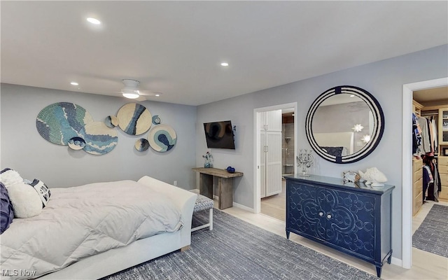 bedroom featuring a walk in closet, recessed lighting, ceiling fan, connected bathroom, and baseboards