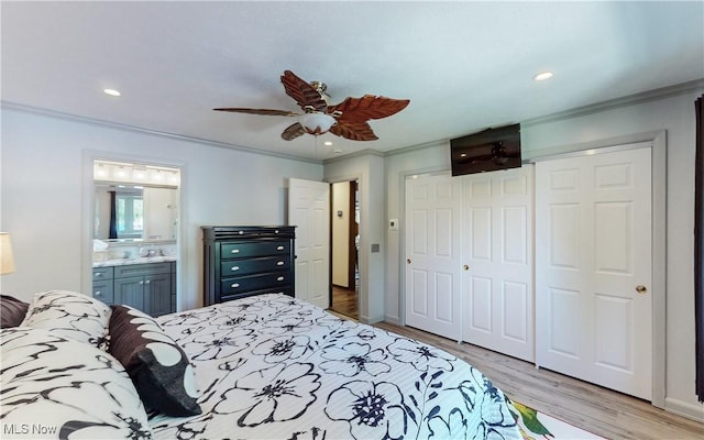 bedroom with ornamental molding, a closet, wood finished floors, recessed lighting, and ensuite bath