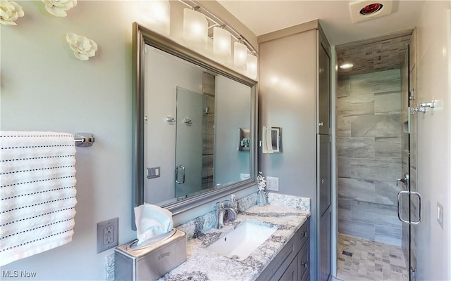 bathroom with a stall shower and vanity