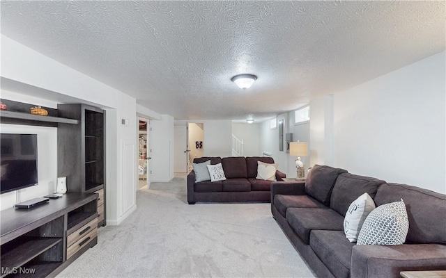 living room with light colored carpet, a textured ceiling, and stairway