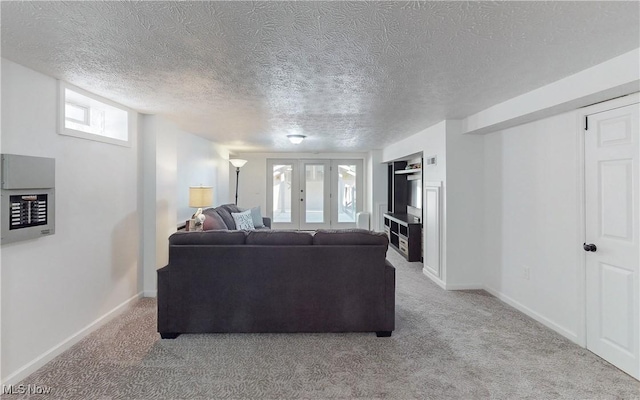 living room featuring light carpet, french doors, baseboards, and a textured ceiling