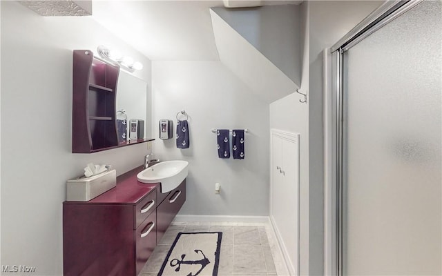 full bath featuring vanity, an enclosed shower, and baseboards