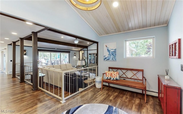 living area featuring wood finished floors, recessed lighting, vaulted ceiling, baseboards, and baseboard heating