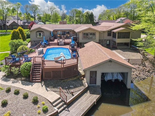 view of swimming pool featuring a wooden deck and stairs
