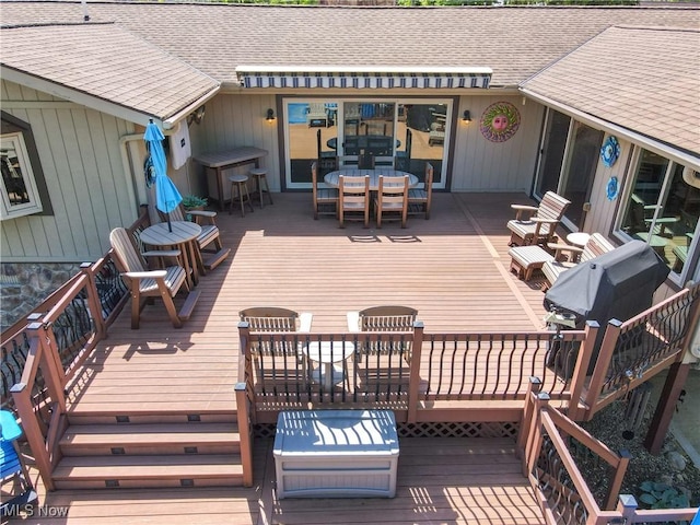 wooden deck with outdoor dining area